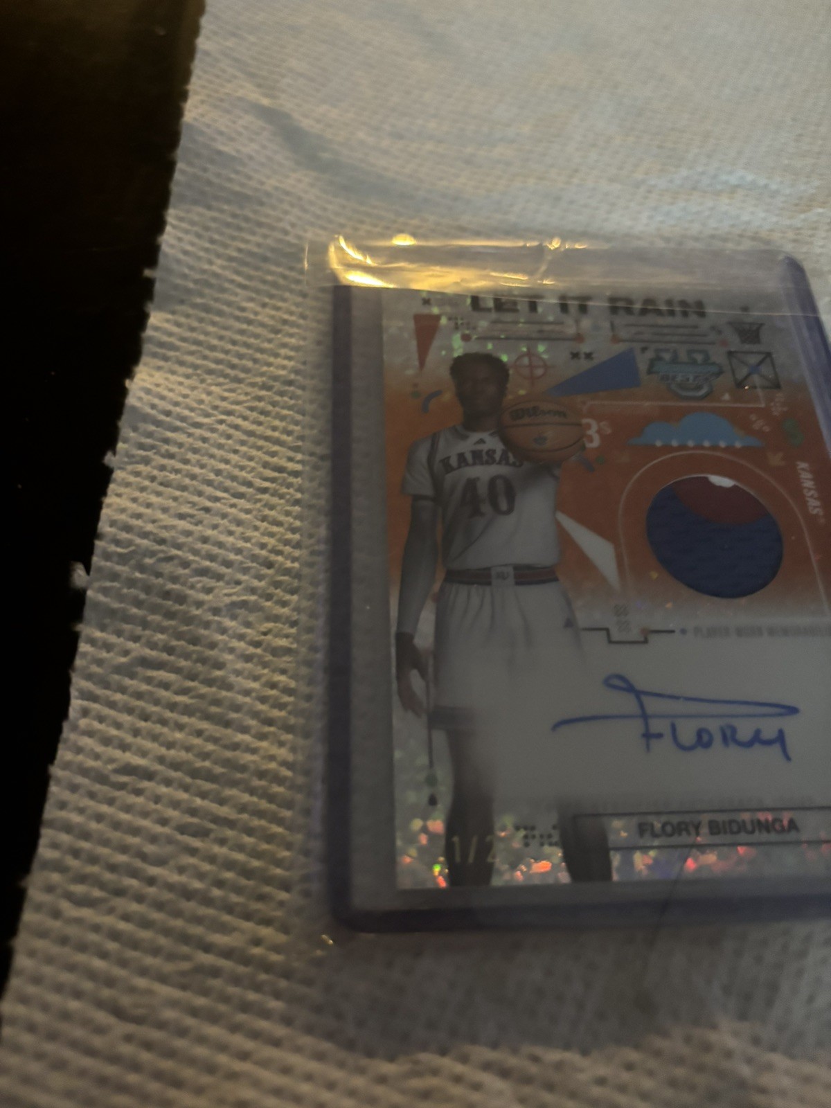 2024-25 Bowman’s Best U Flory Bidunga Rain Patch Auto Orange Mini Diamond #/25