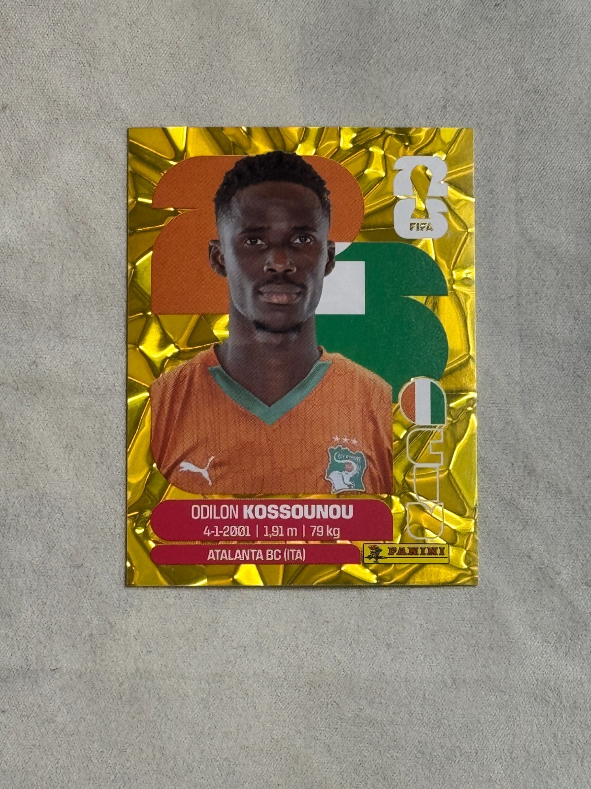 2026 Panini FIFA World Cup Sticker Gold Flood Crumple Odilon Kossounou #CIV5