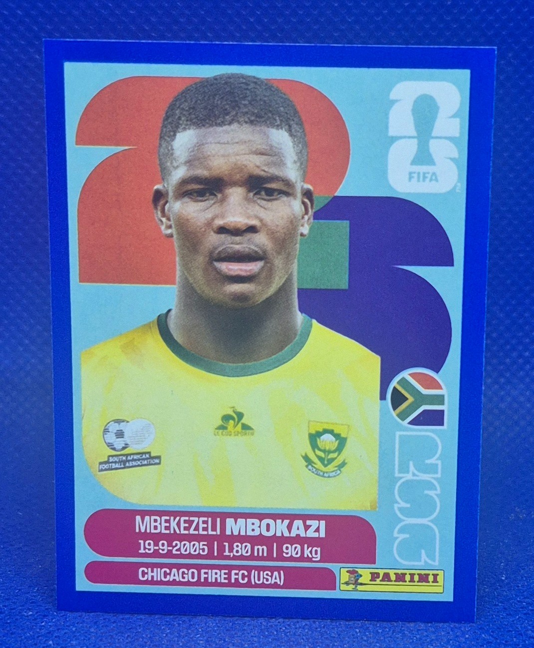 2026 Panini FIFA World Cup Sticker Mbekezeli Mbokazi #RSA 6 – Blue Border