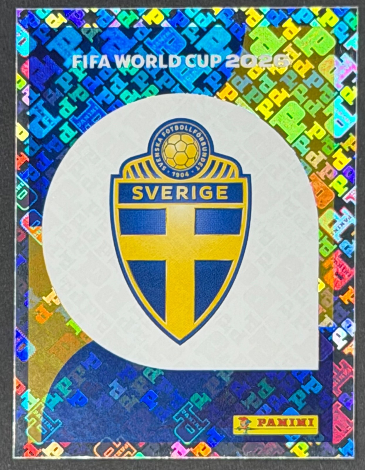 Panini FIFA World Cup 2026 Sticker SWE1 Team Logo – Sweden FOIL