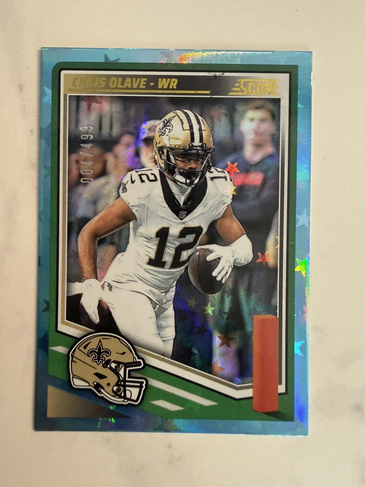 2025 Panini Score Chris Olave #218 Blue Stars /499 New Orleans Saints